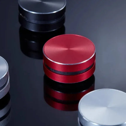 Red circular smart home device with metallic finish and sleek design