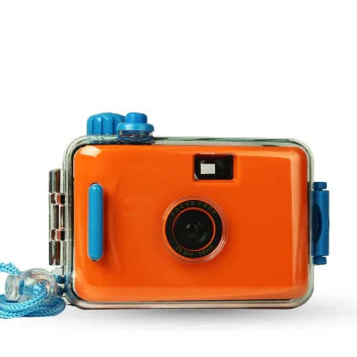 Orange waterproof kids camera with blue accents, floating strap, and clear protective case for underwater use
