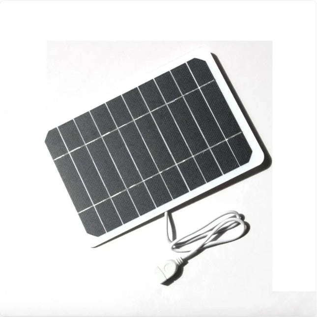 Compact black solar panel with white frame and USB cable for portable charging