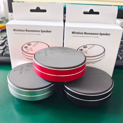 Wireless Resonance Speaker in red, black, and green — compact circular design transforms hollow objects into speakers