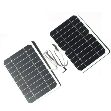 Black solar panels with white grid design, connected by cable for portable power charging