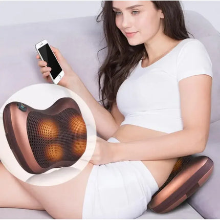 Copper-colored back massager with heated nodes for relaxation, shown in use on a couch