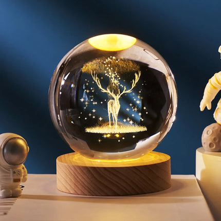 Glowing deer snow globe with starry night design, wooden base, warm LED lighting