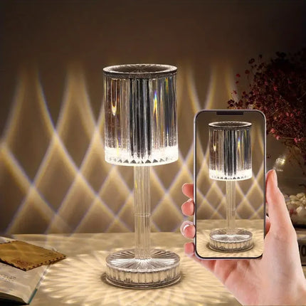 Clear crystal table lamp with ribbed design, emitting warm light, ideal for modern home decor