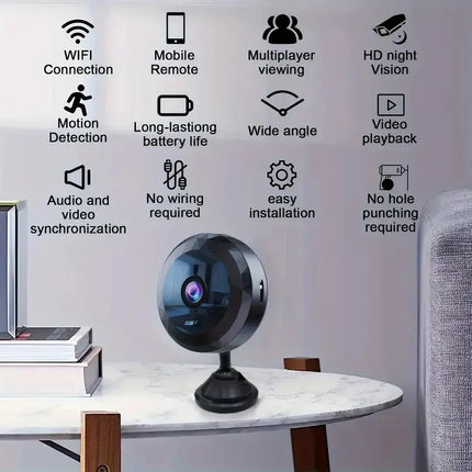 Black wireless security camera with HD night vision, motion detection, and mobile remote control on marble table