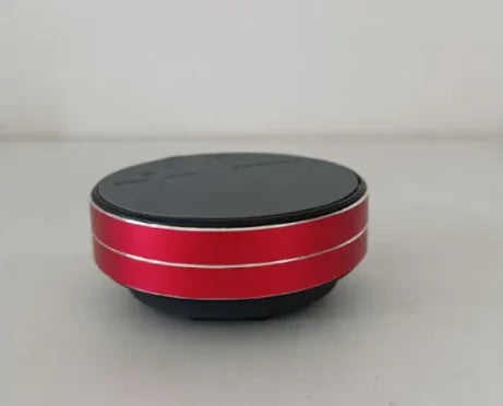 Red and black portable Bluetooth speaker with sleek design and silver accents