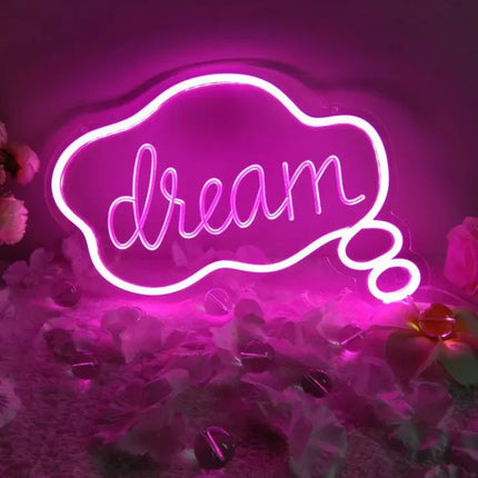 Pink neon sign with 'dream' in cursive, cloud-shaped design, glowing ambiance for room decor