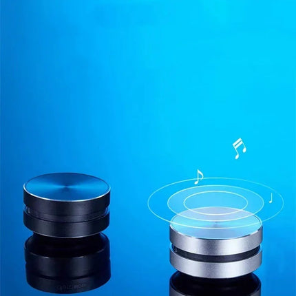 Compact Bluetooth speaker with sleek black and silver design, emitting music notes on blue background