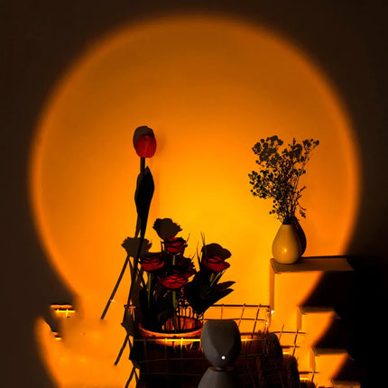 Warm amber moon projector lamp casting circular glow, ideal for cozy bedroom ambiance with floral decor