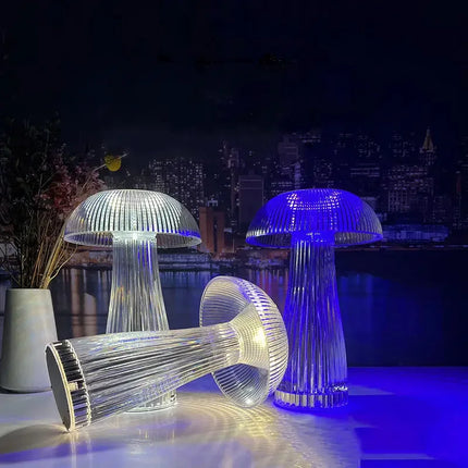 Mushroom-shaped LED table lamp with ribbed clear acrylic design, emitting warm white and cool blue light for modern home decor