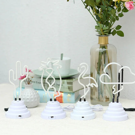 White neon desk lamps shaped as cactus, unicorn, flamingo, and cloud with USB bases for bedroom or office decor