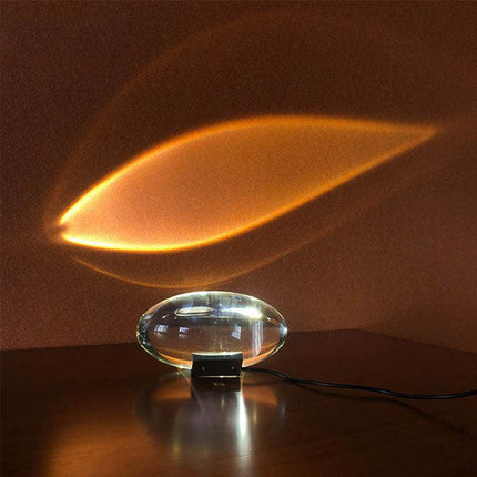 Clear glass table lamp with warm amber glow, modern minimalist design for cozy ambiance