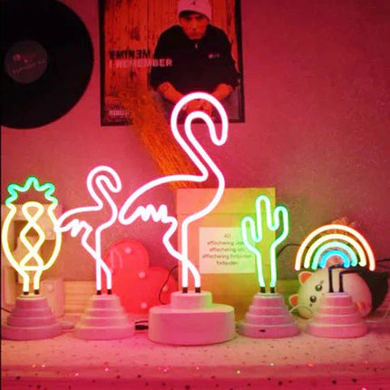 Neon flamingo, cactus, pineapple, and rainbow lights in pink room decor