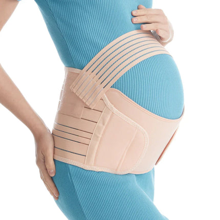 Beige maternity support belt with adjustable straps for pregnancy back pain relief, worn over blue ribbed top