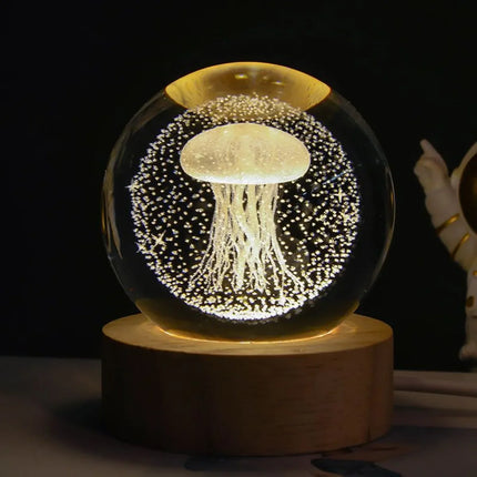 Glowing jellyfish LED night light in glass sphere with wooden base, decorative ambient lighting