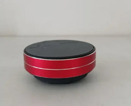 Red and black portable Bluetooth speaker with sleek design and silver accents