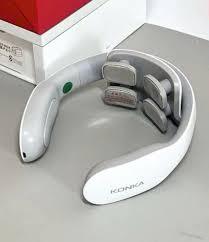White KONICA neck massager with gray rollers, ergonomic design for shoulder and neck relief