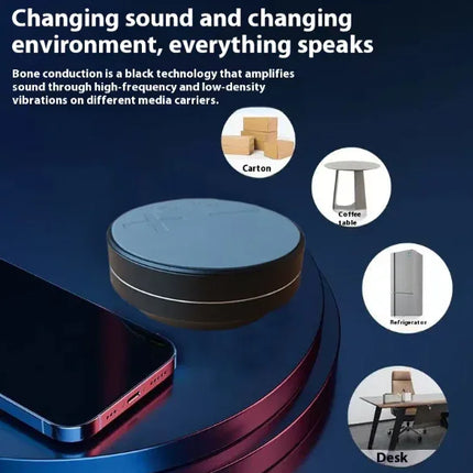 Black bone conduction audio device with sleek design, amplifies sound via vibrations on surfaces like desks, tables, or refrigerators