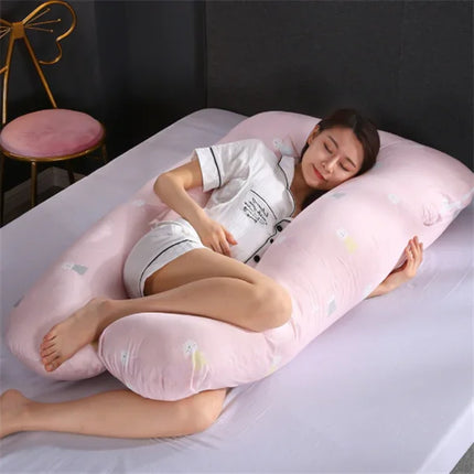 Pink U-shaped pregnancy pillow with cute animal prints, supporting side sleeper for comfort and alignment