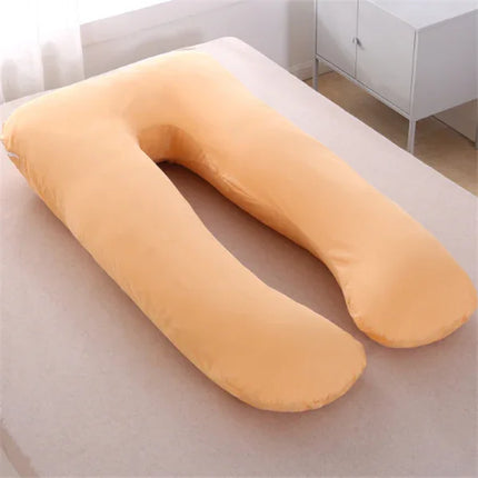 Soft peach U-shaped pregnancy pillow for side sleeping support, cozy design for comfort and alignment