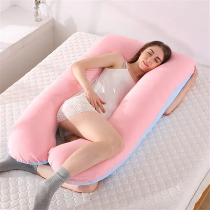 Pink U-shaped pregnancy pillow with blue trim, supporting side sleeper for comfort and alignment
