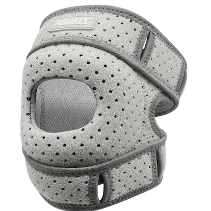 Gray perforated knee brace with adjustable straps for support and comfort during activity